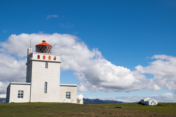 Lighthouse over Black sand beach - island