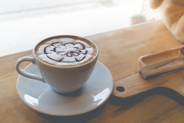 hot coffee with foam milk art in afternoon break