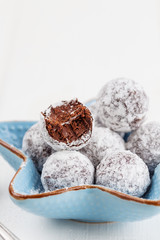 Bitten chocolate truffle in sugar powder