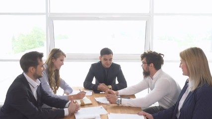 Successful negotiations of a group of young businessman in the office of the company. business meeting. Handshake of businessman at the conclusion of the transaction.