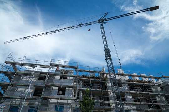 Blue Construction Crane With A New Building In Front