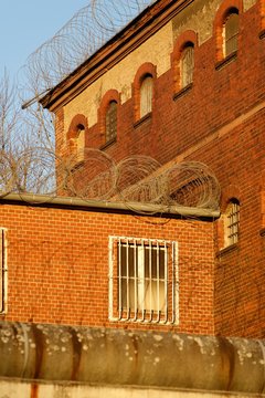 The outside view of an old and abandoned jail in Berlin during sunset