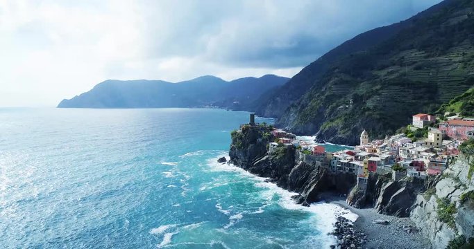 aerial view of travel landmark destination Vernazza, a small mediterranean sea town, Cinque terre National Park, Liguria, Italy. Afternoon sunny and cloud weather. 4k aerial drone forward video shot