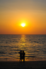 Beautiful Sunset at andaman sea with silhouette people together