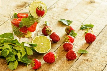 Refreshing drink with strawberry, lime and mint