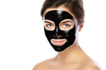 Woman with purifying black mask on her face