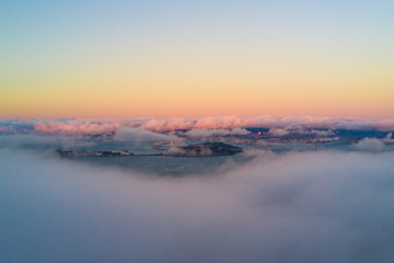 Fototapeta premium Aerial photo of fog rolling over the Bay Area