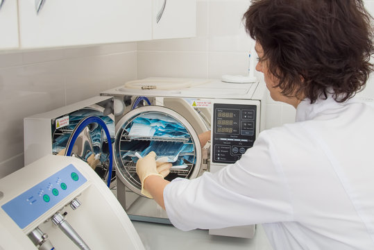 Instrument Sterilization In Dentistry, Nurse Loading Instrumenst In Sterilizer.