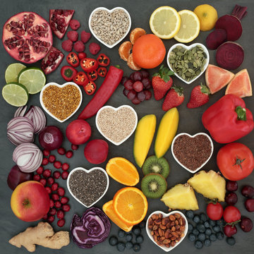 Paleolithic diet food of fresh fruit, vegetables, nuts and seeds on slate background. High in antioxidants, vitamins, anthocyanins and dietary fiber