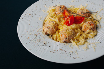 delicious fettuccine pasta with prawns on a white plate