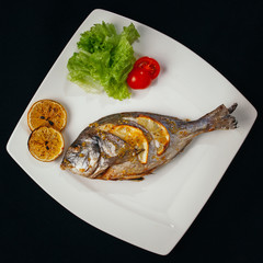 Grilled dorada fish with lemon and spinach