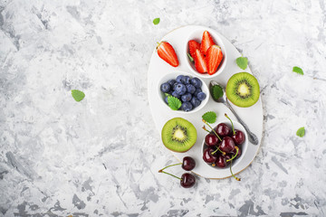 Ingredients healthy diet family meals: fresh juicy fruits and berries with mint and ice to prepare a healthy summer desserts, refreshing beverages, to add to cereal, for making smoothies on a light