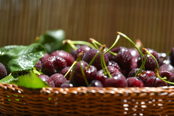 Fresh and ripe cherry berries in a wooden wicker basket
