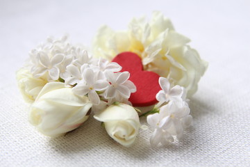 Fototapeta na wymiar Beautiful white flowers and red hearts on white background.