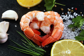Delicious sauteed shrimp heart with cajun seasoning and lime on dark stone