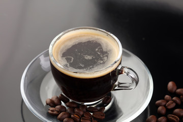 Coffee cup and coffee beans on table