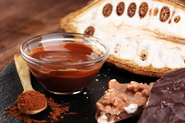 Melting chocolate and diffrent bars - stack and chips with chocolate swirl/ powder and cocoa pod with melted chocolate