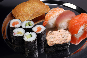 close up of sashimi sushi set with chopsticks and soy - sushi roll with salmon and sushi roll, delicious maki and nigiri