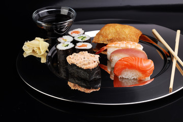 close up of sashimi sushi set with chopsticks and soy - sushi roll with salmon and sushi roll, delicious maki and nigiri