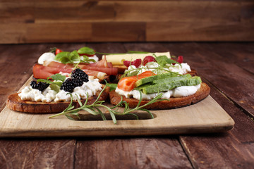 Bread Brushetta or authentic traditional spanish tapas set for lunch table. Sharing antipasti on party or summer picnic time over wooden rustic background.