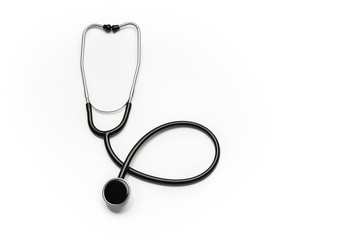 Stethoscope isolated on white background. Sterile doctors office desk. Medical accessories on a white table background with copy space around products. Photo taken from above.