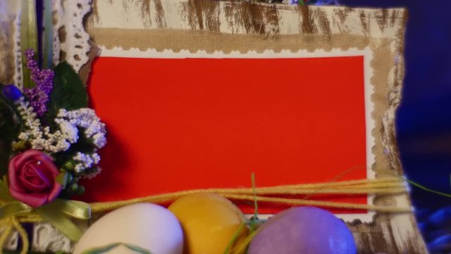 Photo Frame From Natural Wood and Fabric Among Traditional Easter Gifts on a Round Table With Hen and Quail Eggs