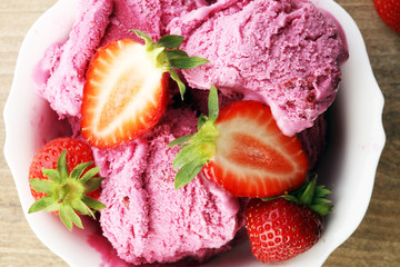 Strawberry ice cream on brown wood background