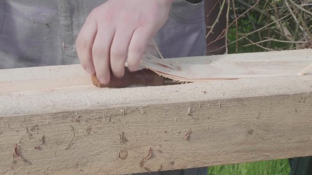 Carpenter makes dap working with chisel