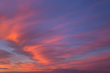 Beautiful dramatic sunrise blue sky with orange colored clouds 