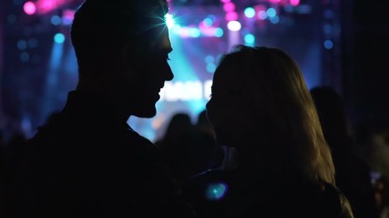 Night club atmosphere, loving couple dancing and laughing at music festival