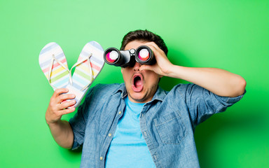 Young surprsied man with binocular