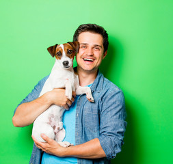 Handsome smiling man with young dog