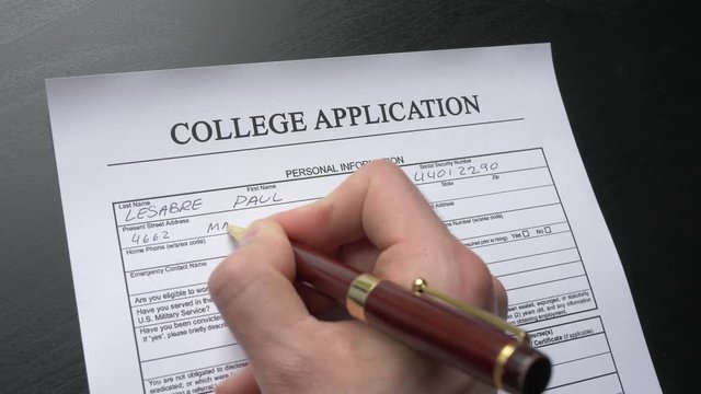 A person filling a college application form. Closeup shot.