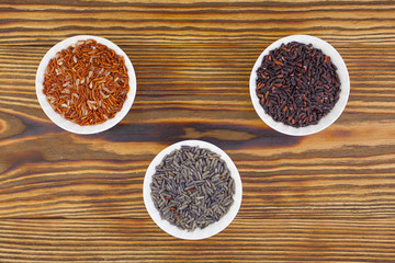 Raw blue rice in bowl on  wooden background