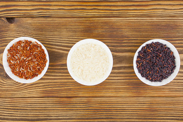 Raw blue rice in bowl on  wooden background