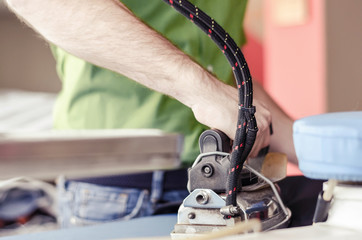 Young Happy Man Ironing Clothes On Ironing Board