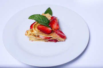 Pancakes with strawberries and mint pie with strawberries