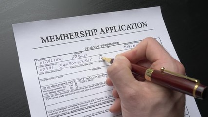 A person filling a membership form. Closeup shot.