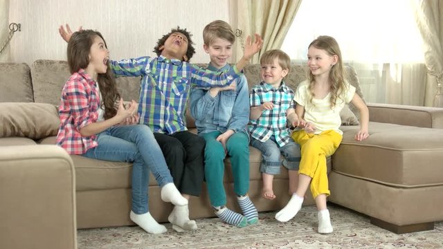 Kids playing rock paper scissors. Group of children indoor. Family competition games.