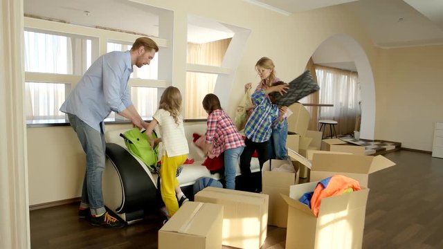 Family moving out. People packing boxes indoors. Importance of helping each other.