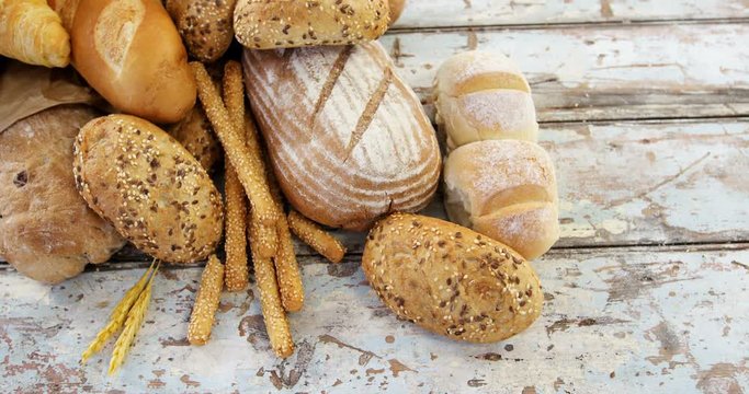 Various bread loaves on wooden table