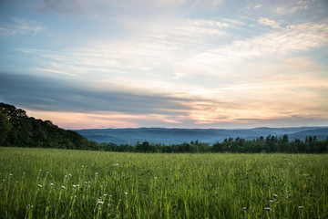 Beautiful Sunset over Meadow with Mountain View

