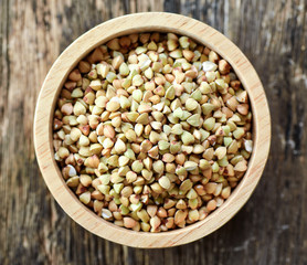 Buckwheat in wood bowl on table