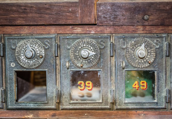 horizontal image of very old vintage US mail boxes.