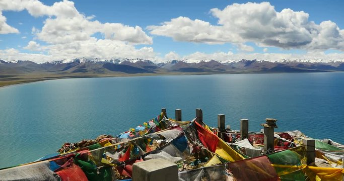 4k huge clouds mass rolling over lake namtso & Tanggula snow mountain peak,tibet mansarovar,pray flag in wind,Tibet's second largest lake,the third largest saltwater lake in China.roof of the World.
