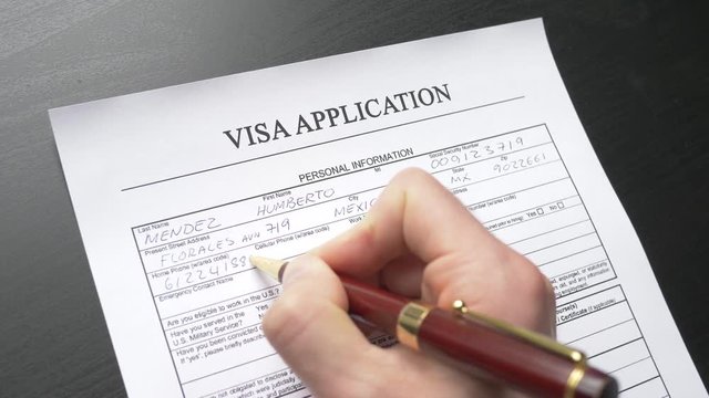 A person filling a  visa form. Closeup shot.