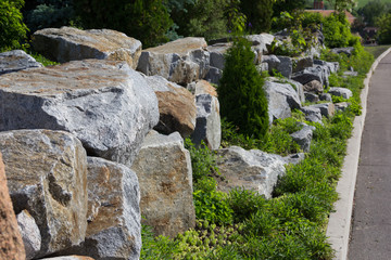 Gray stones boulders on a green grass © Angelika Smile