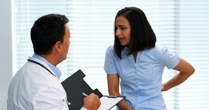 Patient suffering from stomach ache while consulting doctor