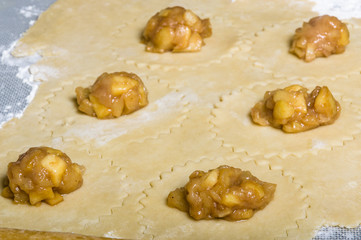 Apple filling on dough sheet