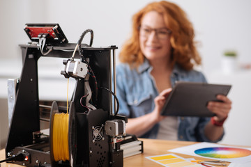 Obraz na płótnie Canvas Selective focus of a filament being put into 3d printer